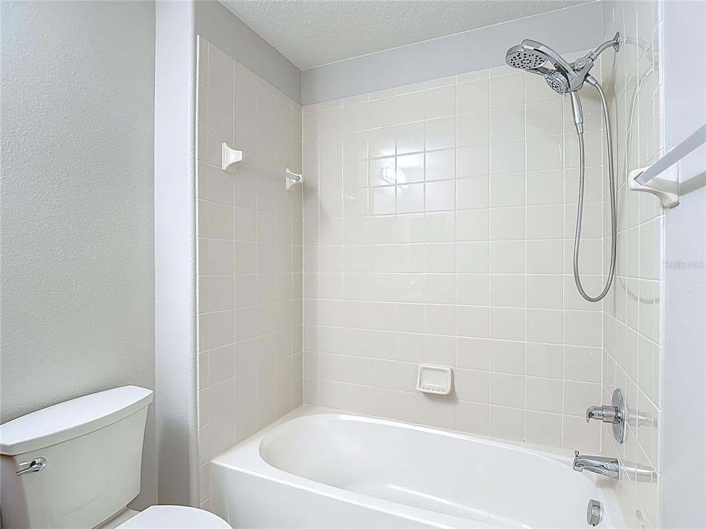 20451 Berrywood Lane Tampa, FL 33647 - Photo 45 of 57 a white bath tub sitting next to a white toilet and a shower