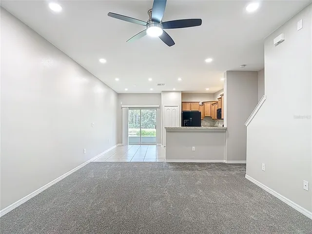 a kitchen with stainless steel appliances granite countertop a refrigerator stove and sink