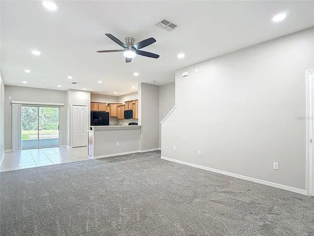a large kitchen with a sink and stainless steel appliances
