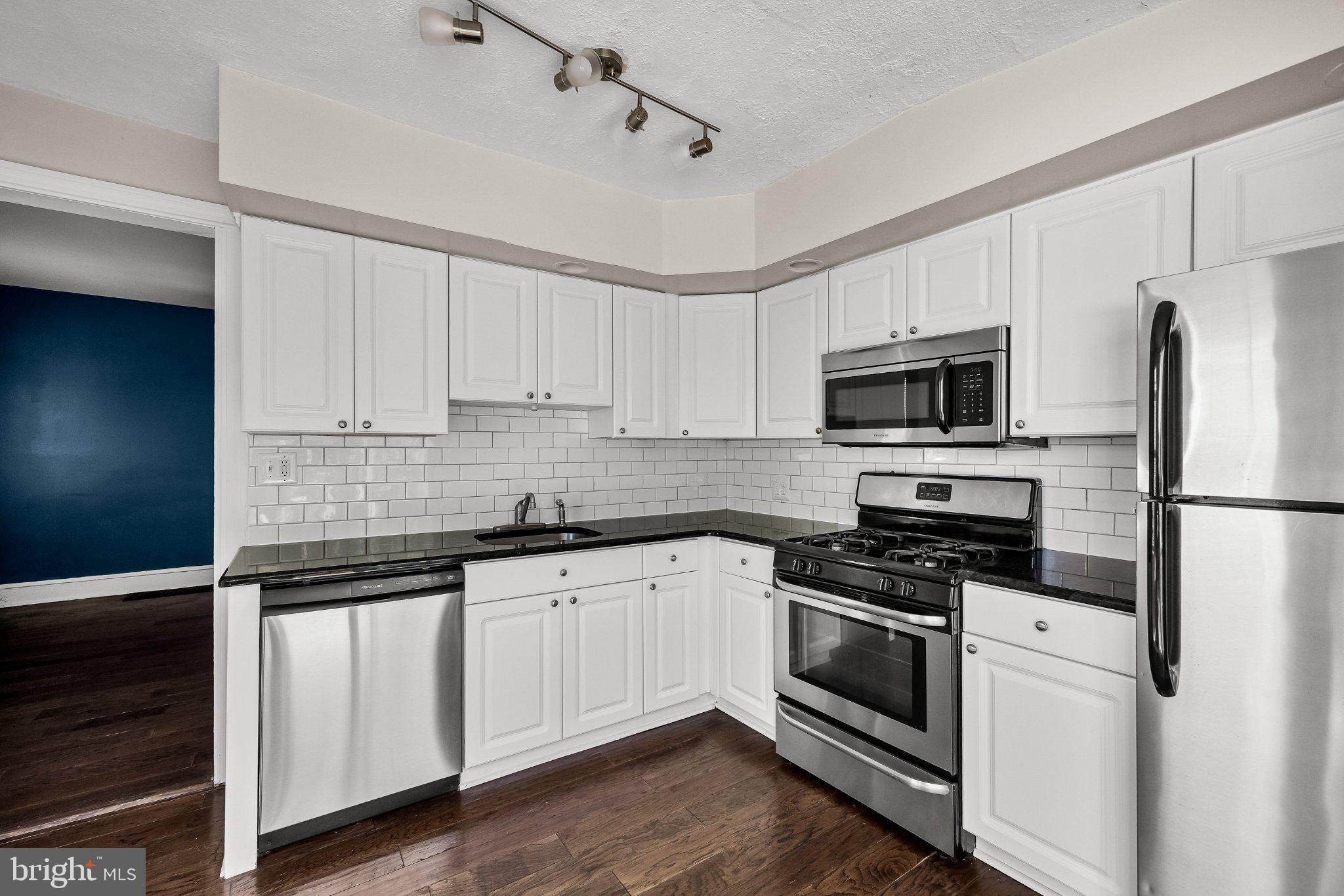 36 Brainerd Street Mount Holly, NJ 08060 - Photo 1 of 28 a kitchen with white cabinets stainless steel appliances and sink