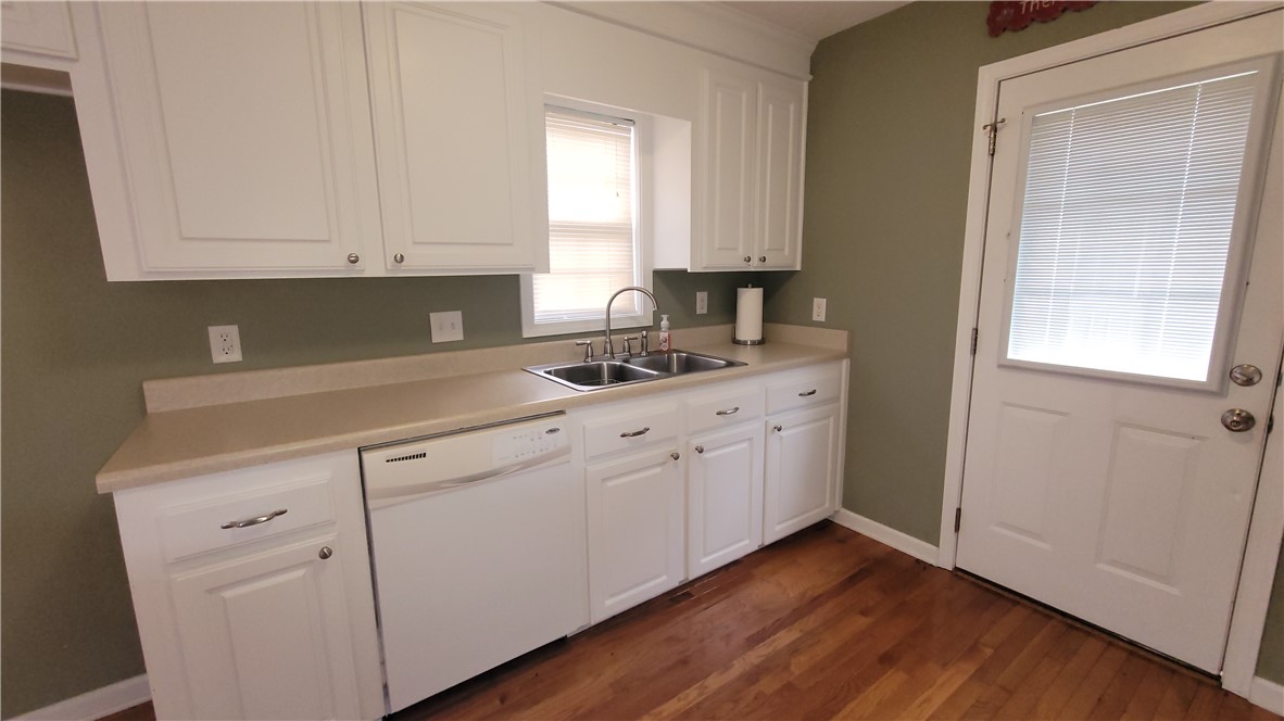 325 McAdams School Road Honea Path, SC 29654 - Photo 7 of 22 Well-lit kitchen with classic white cabinetry and durable wood flooring.