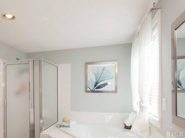 2337 Florida Court Raleigh, NC 27615 - Photo 16 of 25 For your bathing needs there is a large corner garden tub and a walk-in shower. The homeowner has hired the Grout Medic to refurbish the tile and grout in the master shower.