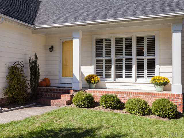 New plantation shutters add a dose of charm to the curb appeal of the home. This pretty home is located on  the left as you enter a long cul-se sac