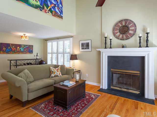 The gas fireplace features a  tall mantel with slate surround.