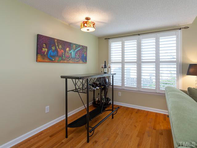 The current homeowner uses this flex space as a wine bar for entertaining guests. This area has also been used as a location for a dining room table.