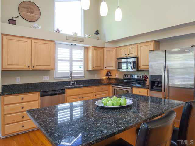 The large work island is perfect for entertaining guests as well as a convenient spot for casual dining. Notice how the granite sparkles!