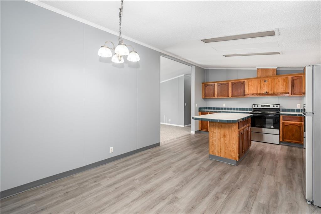 194 Andrusky Road Mercer, PA 16137 - Photo 12 of 29 a kitchen with stainless steel appliances granite countertop a sink a stove a refrigerator and island with wooden floor