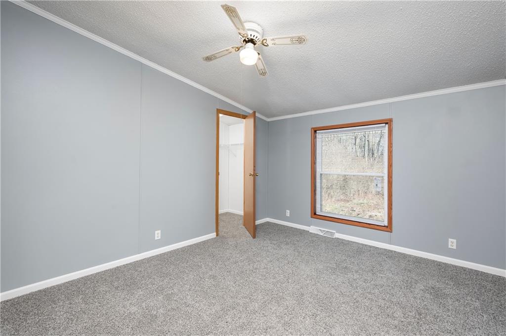 194 Andrusky Road Mercer, PA 16137 - Photo 18 of 29 an empty room with windows and fan