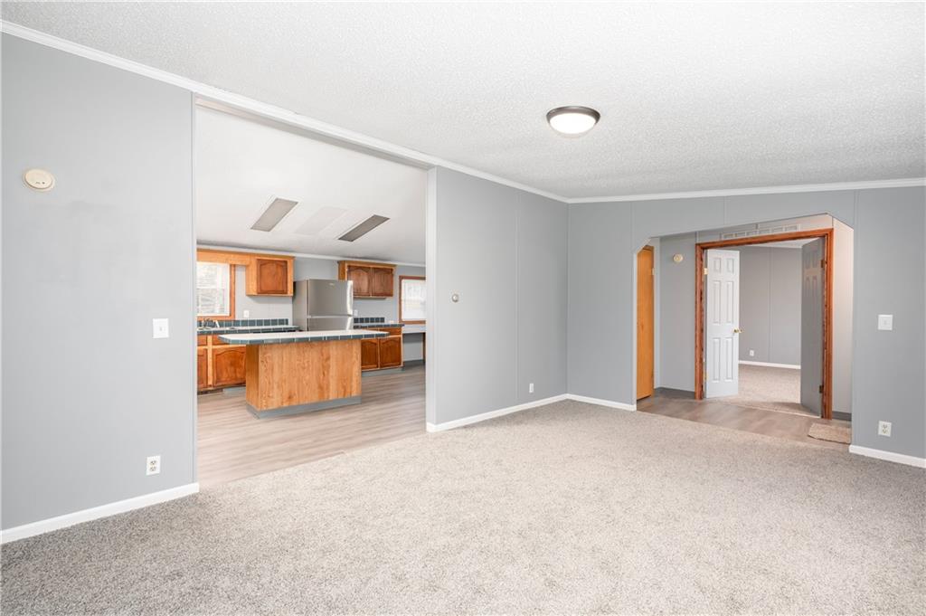 194 Andrusky Road Mercer, PA 16137 - Photo 5 of 29 an empty room with kitchen view and a window