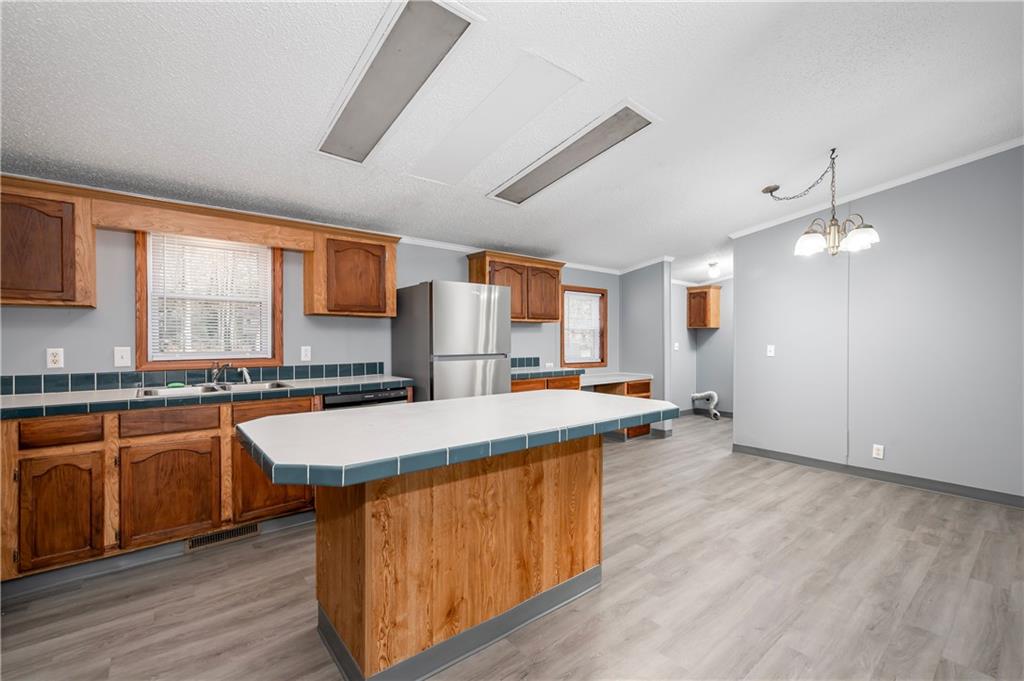 194 Andrusky Road Mercer, PA 16137 - Photo 6 of 29 a kitchen with stainless steel appliances granite countertop a sink a stove and a wooden floors
