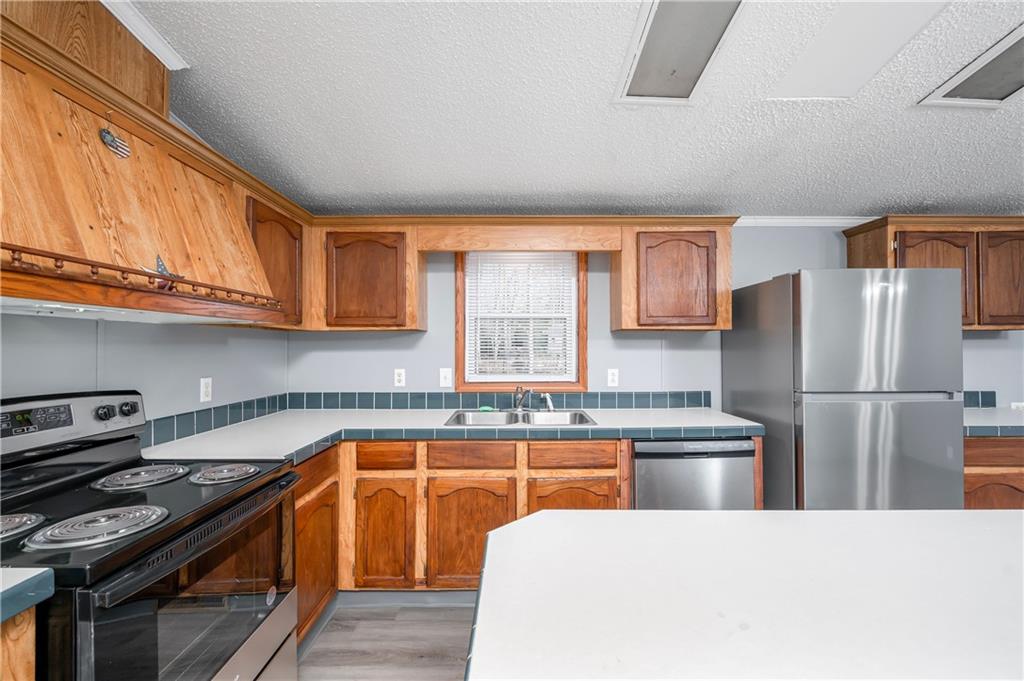 194 Andrusky Road Mercer, PA 16137 - Photo 7 of 29 a kitchen with stainless steel appliances granite countertop a stove a refrigerator a sink and dishwasher