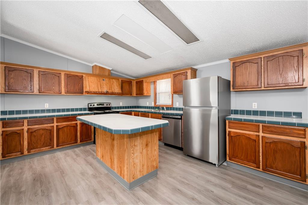 194 Andrusky Road Mercer, PA 16137 - Photo 8 of 29 a kitchen with stainless steel appliances granite countertop a refrigerator a stove a sink and a microwave