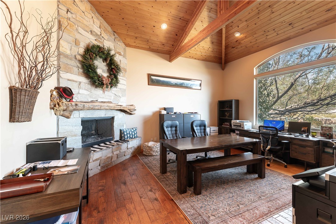 13675 Racel Street Las Vegas, NV 89166 - Photo 18 of 55 Office area featuring light wood-style floors, a wooden ceiling with exposed beams, a stone fireplace, and high vaulted ceiling