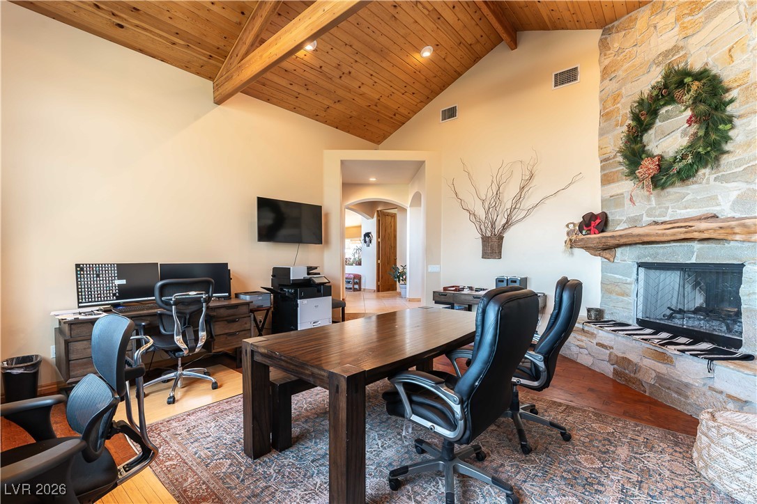 13675 Racel Street Las Vegas, NV 89166 - Photo 19 of 55 Office space featuring arched walkways, a stone fireplace, wood finished floors, a wooden ceiling with exposed beams, and recessed lighting