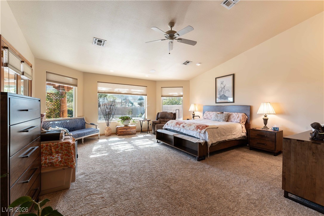 13675 Racel Street Las Vegas, NV 89166 - Photo 21 of 55 Bedroom with light colored carpet, a ceiling fan, and vaulted ceiling