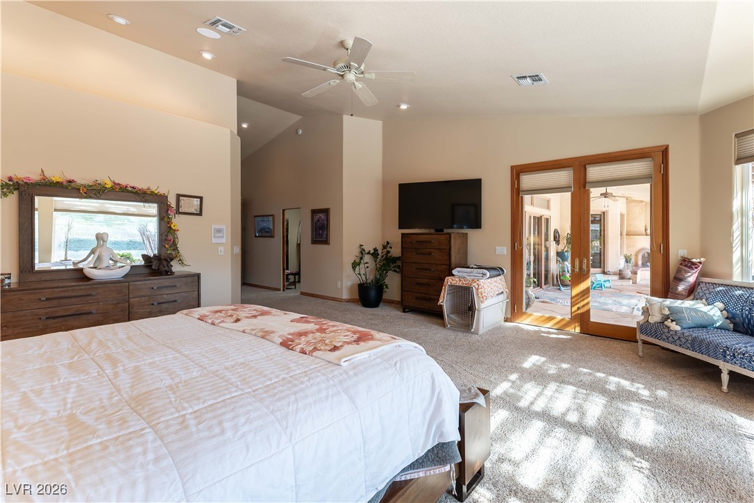 13675 Racel Street Las Vegas, NV 89166 - Photo 24 of 55 Carpeted bedroom with multiple windows, access to exterior, ceiling fan, and high vaulted ceiling