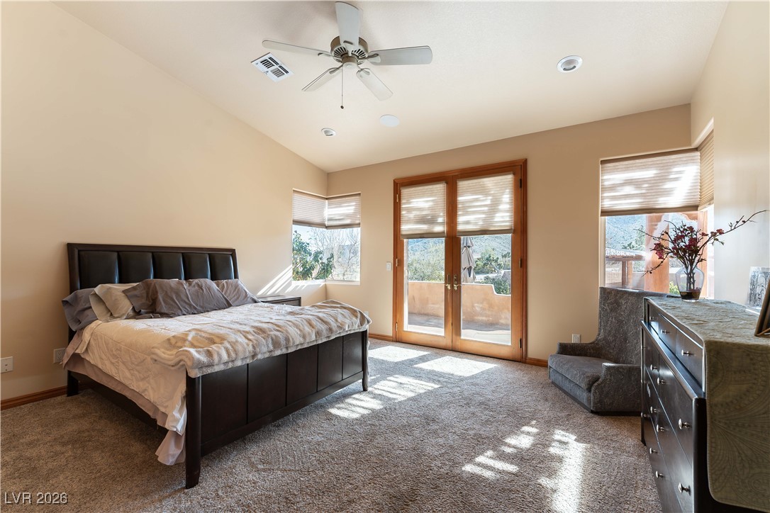 13675 Racel Street Las Vegas, NV 89166 - Photo 29 of 55 Bedroom with lofted ceiling, access to exterior, a ceiling fan, carpet flooring, and french doors