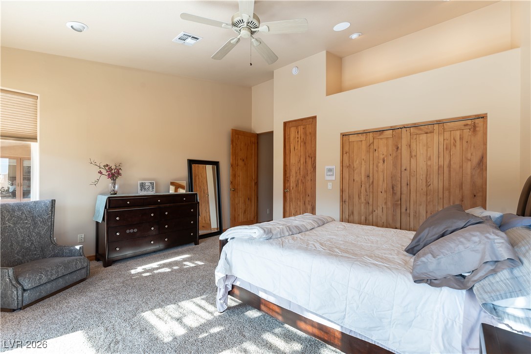 13675 Racel Street Las Vegas, NV 89166 - Photo 30 of 55 Carpeted bedroom with a closet, ceiling fan, and a high ceiling