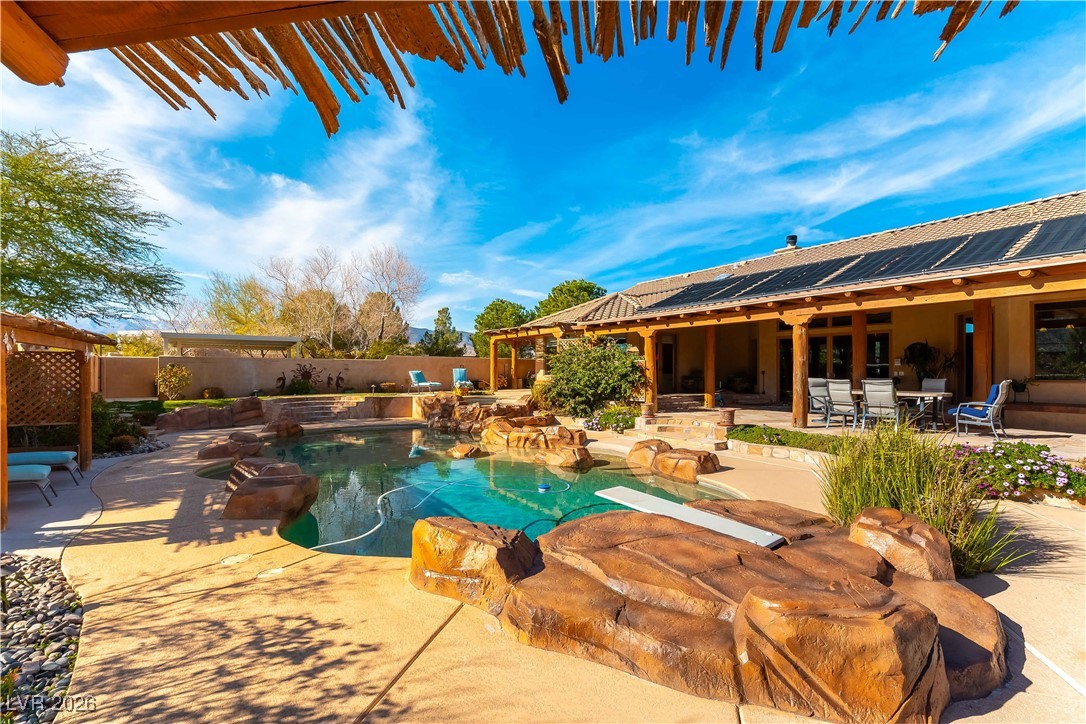 13675 Racel Street Las Vegas, NV 89166 - Photo 36 of 55 View of swimming pool with a patio area, a fenced backyard, and outdoor dining area
