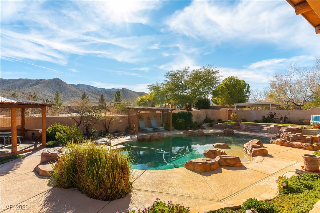 13675 Racel Street Las Vegas, NV 89166 - Photo 39 of 55 View of pool with a patio area, a fenced backyard, and a mountain view