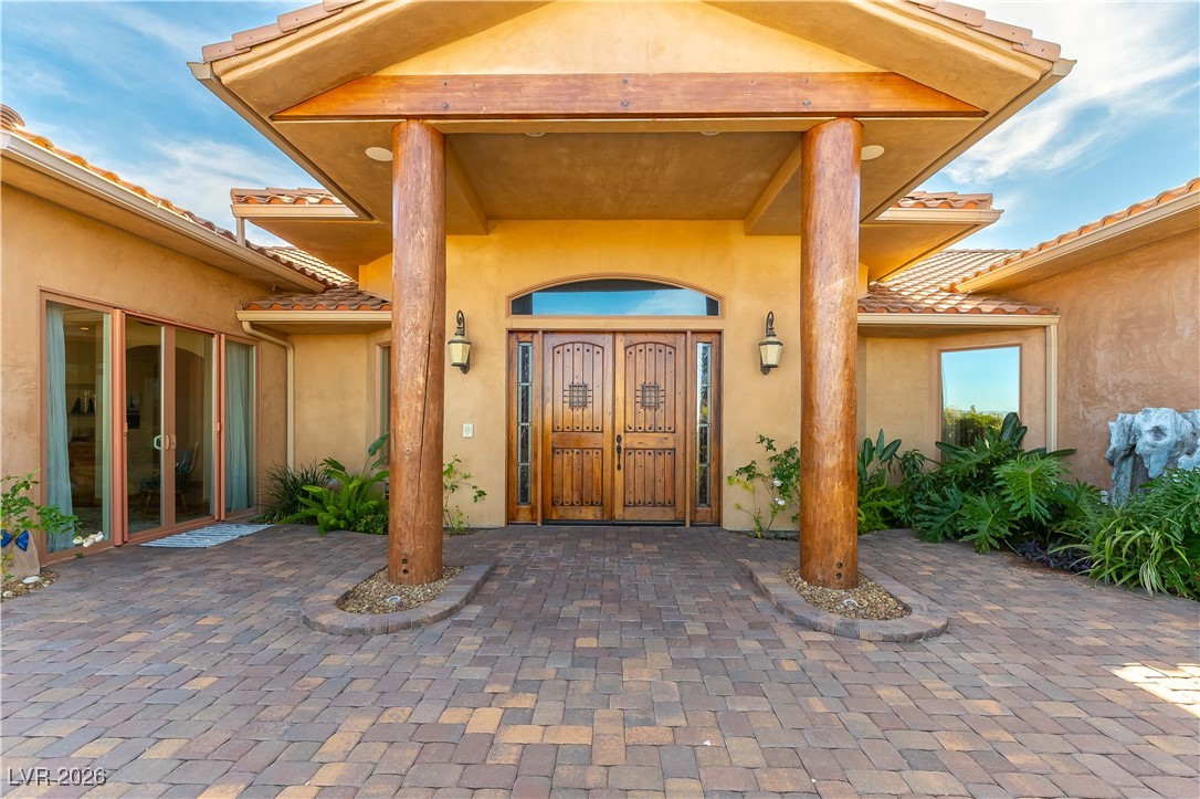 13675 Racel Street Las Vegas, NV 89166 - Photo 4 of 55 View of exterior entry featuring stucco siding, a tile roof, and french doors