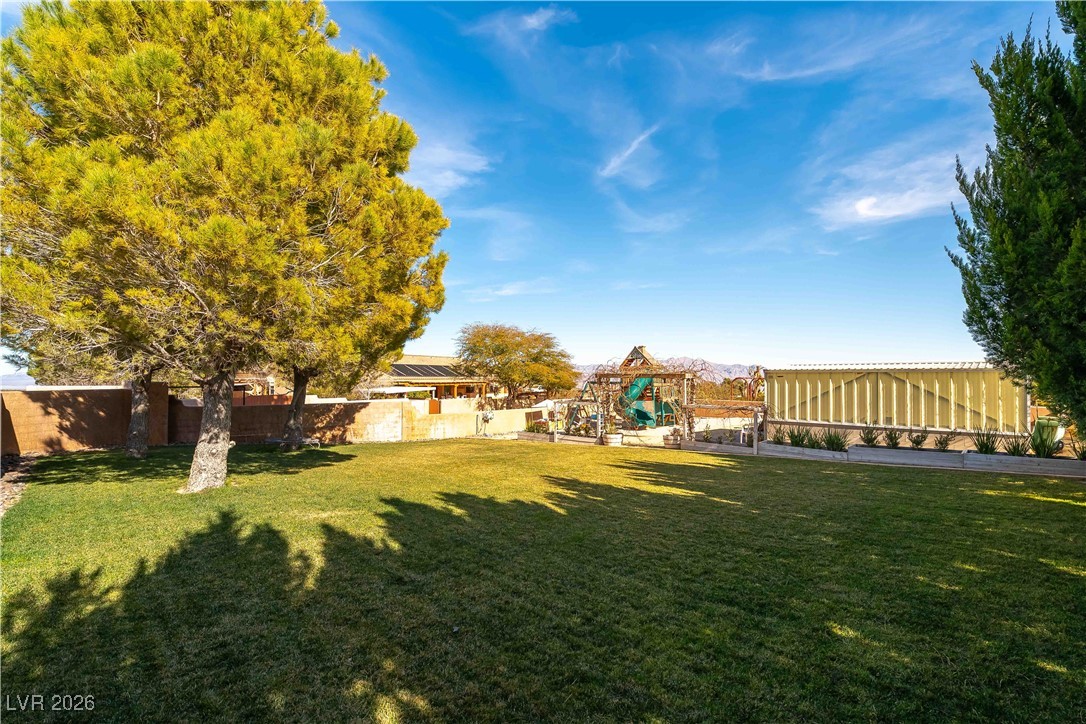 13675 Racel Street Las Vegas, NV 89166 - Photo 43 of 55 Fenced backyard featuring a playground