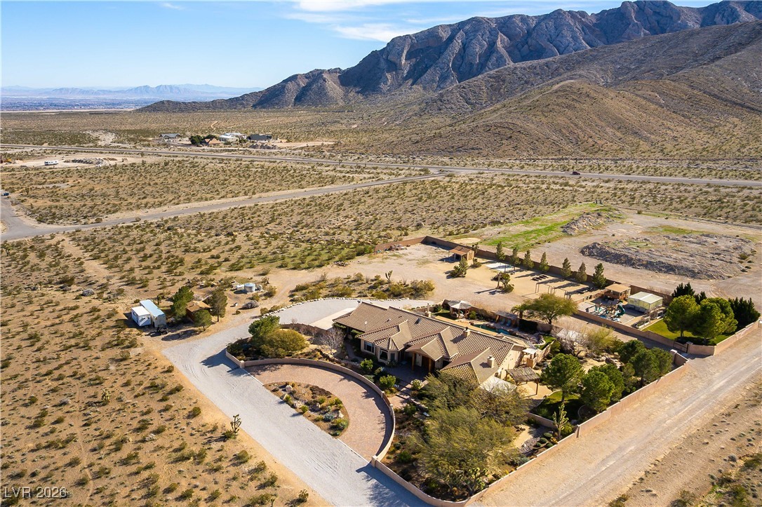 13675 Racel Street Las Vegas, NV 89166 - Photo 50 of 55 Aerial view of sparsely populated area featuring a mountain backdrop and a desert landscape