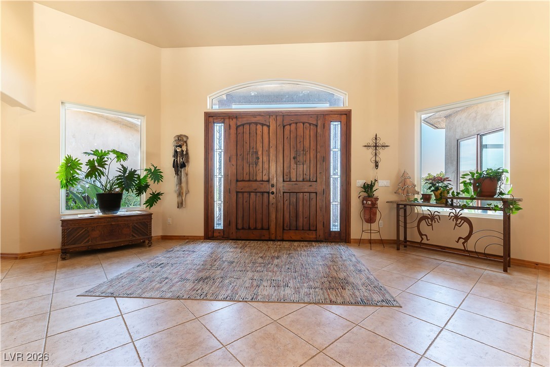 13675 Racel Street Las Vegas, NV 89166 - Photo 5 of 55 Entryway with light tile patterned floors and a high ceiling