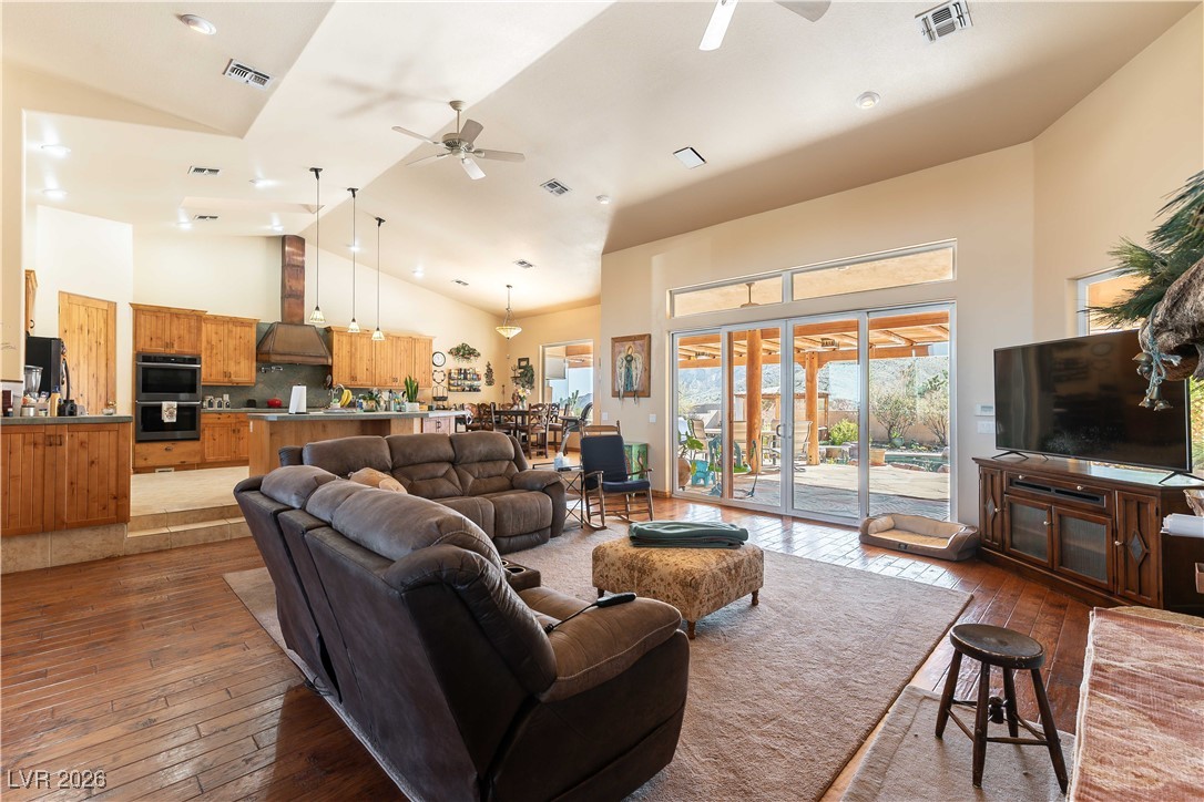 13675 Racel Street Las Vegas, NV 89166 - Photo 7 of 55 Living room featuring light wood finished floors, high vaulted ceiling, a ceiling fan, and recessed lighting
