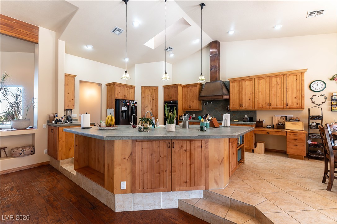 13675 Racel Street Las Vegas, NV 89166 - Photo 10 of 55 Kitchen with a skylight, decorative light fixtures, high vaulted ceiling, black appliances, and a large island with sink