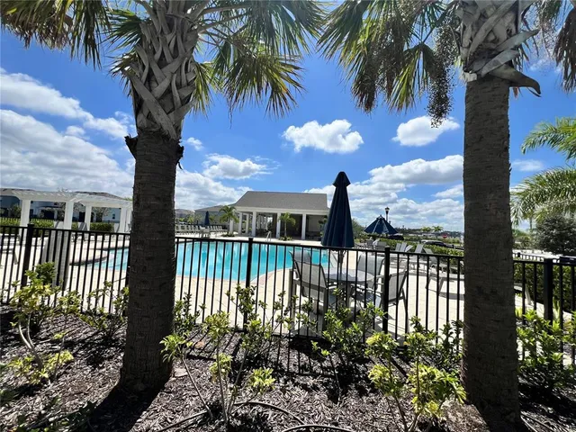 a view of a patio with a table and chairs