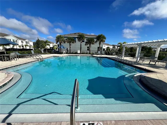 a view of a swimming pool with a bench in the patio