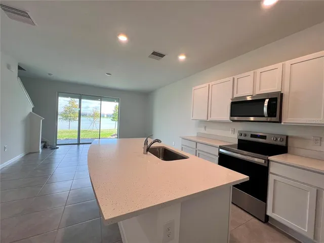a kitchen with a sink a stove and microwave