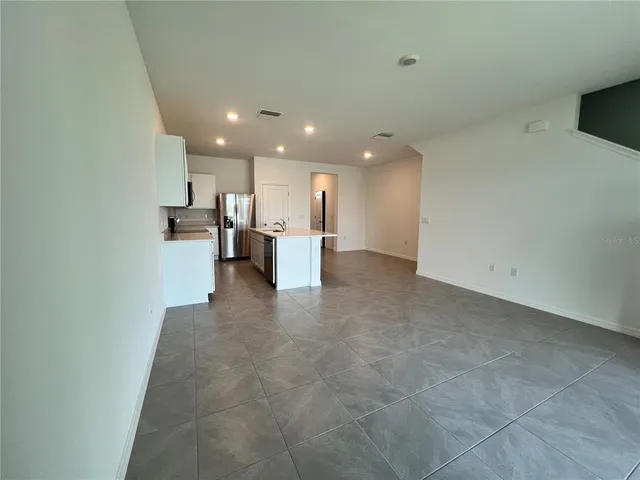 a view of a kitchen with a sink and cabinets