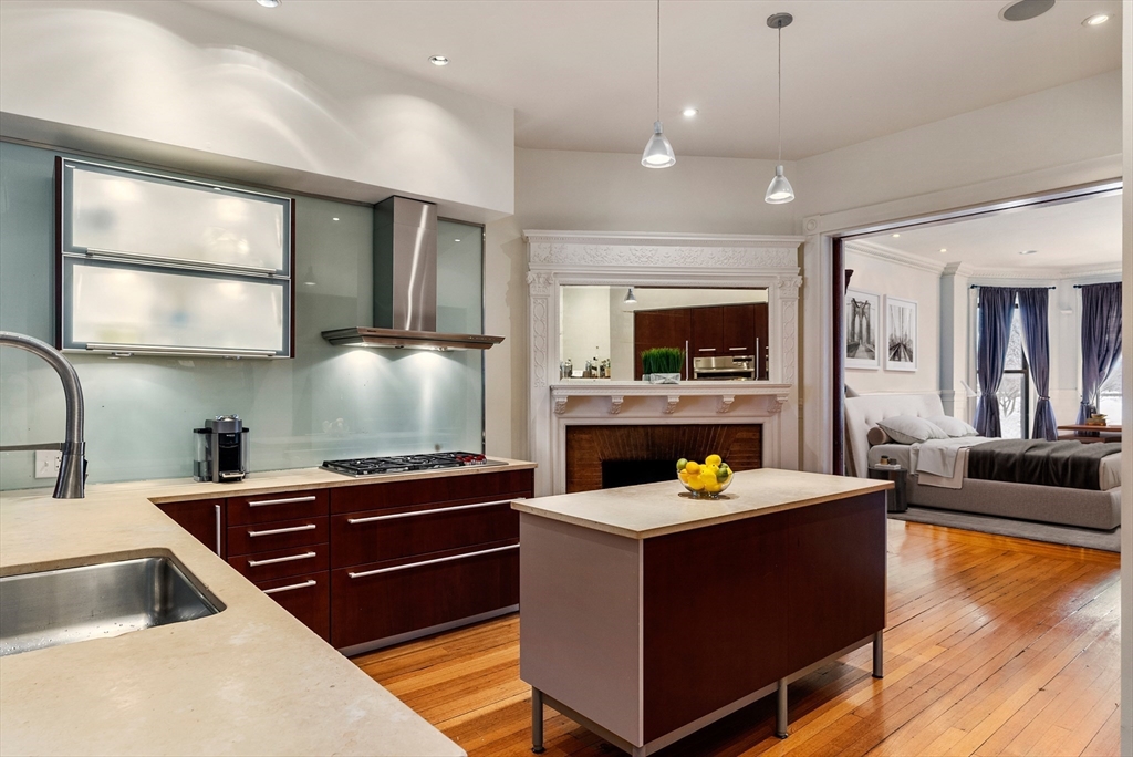 37 Bay State Road, Unit 3 Boston, MA 02215 - Photo 6 of 18 a living room with stainless steel appliances kitchen island granite countertop a sink and a stove