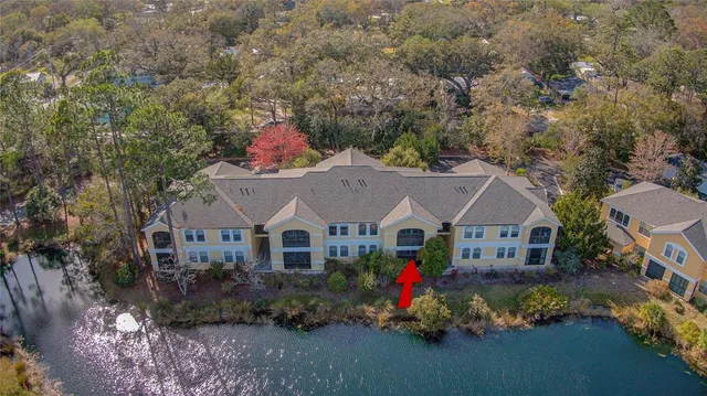 a front view of house with yard and trees in the background