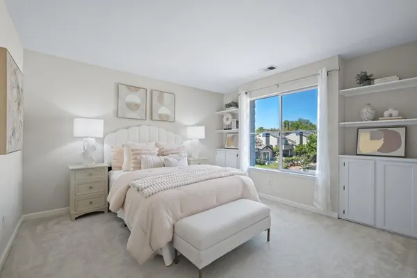 a bedroom with a bed and a window