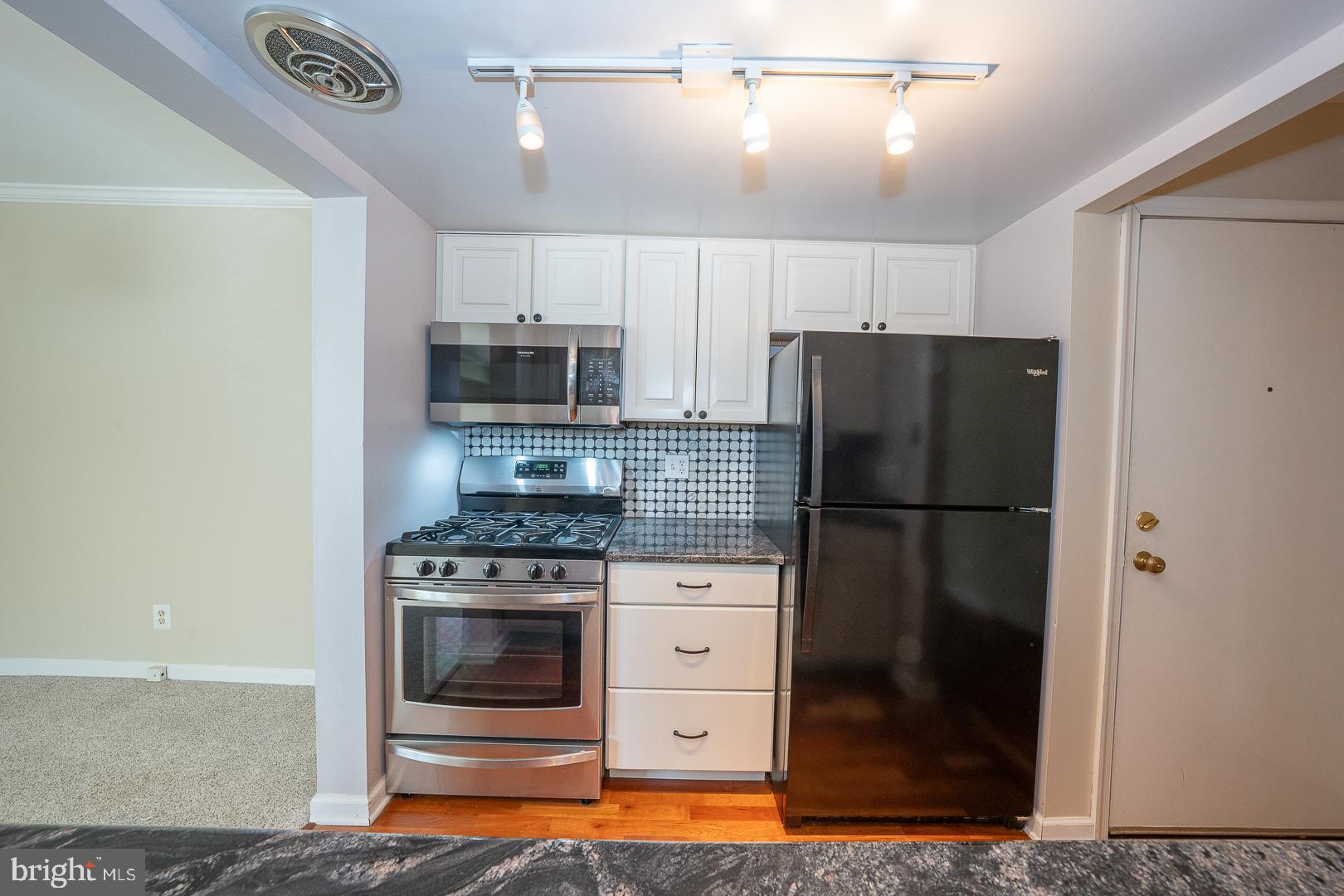 441 Drummers Lane, Unit 441 Wayne, PA 19087 - Photo 18 of 32 a kitchen with a refrigerator and a stove