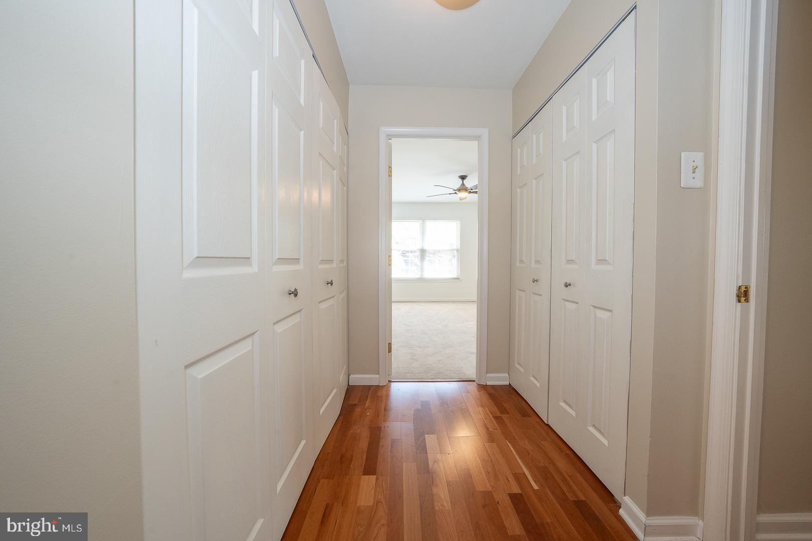 441 Drummers Lane, Unit 441 Wayne, PA 19087 - Photo 20 of 32 a view of a hallway with wooden floor and a bathroom