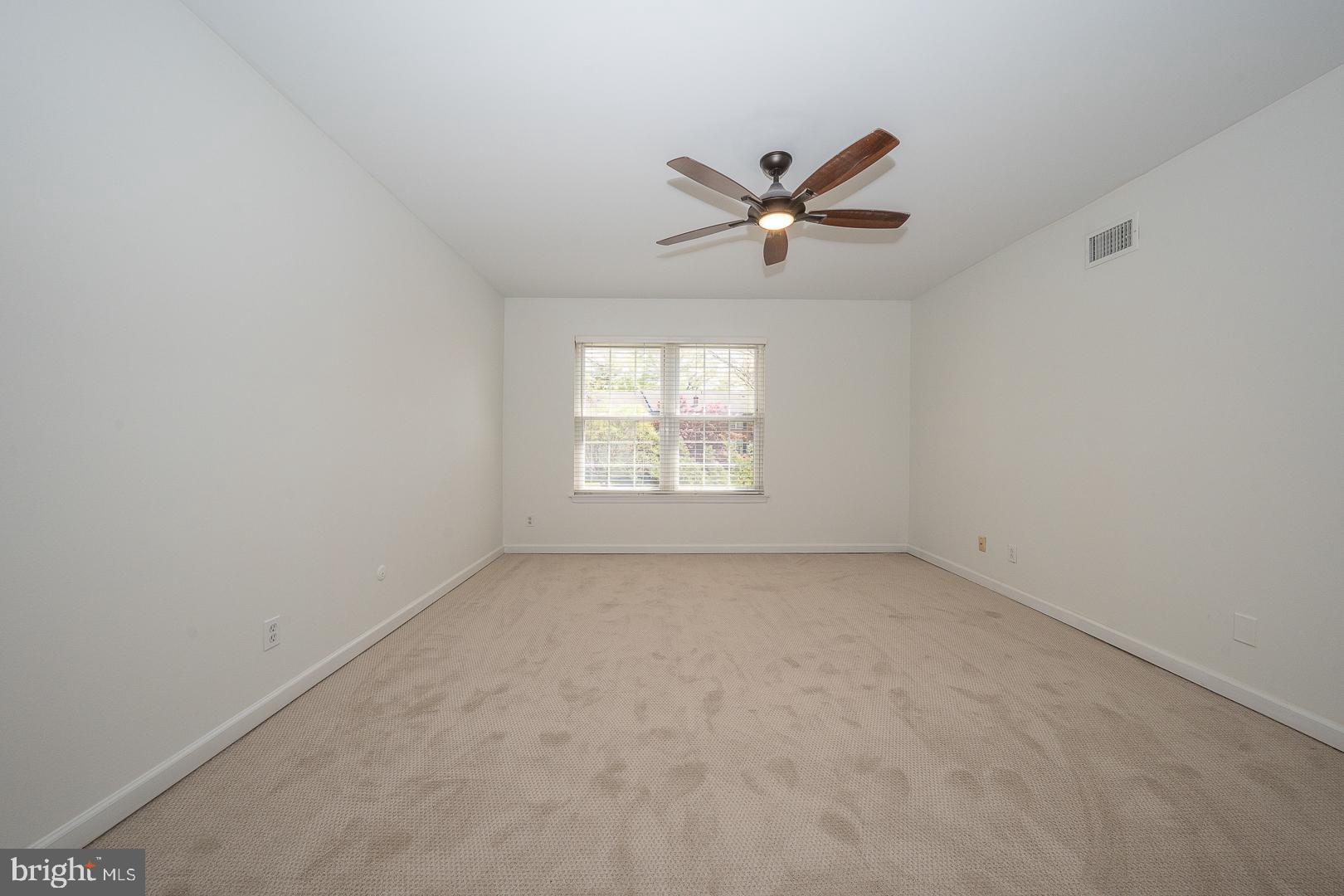 441 Drummers Lane, Unit 441 Wayne, PA 19087 - Photo 21 of 32 an empty room with a window and a fan