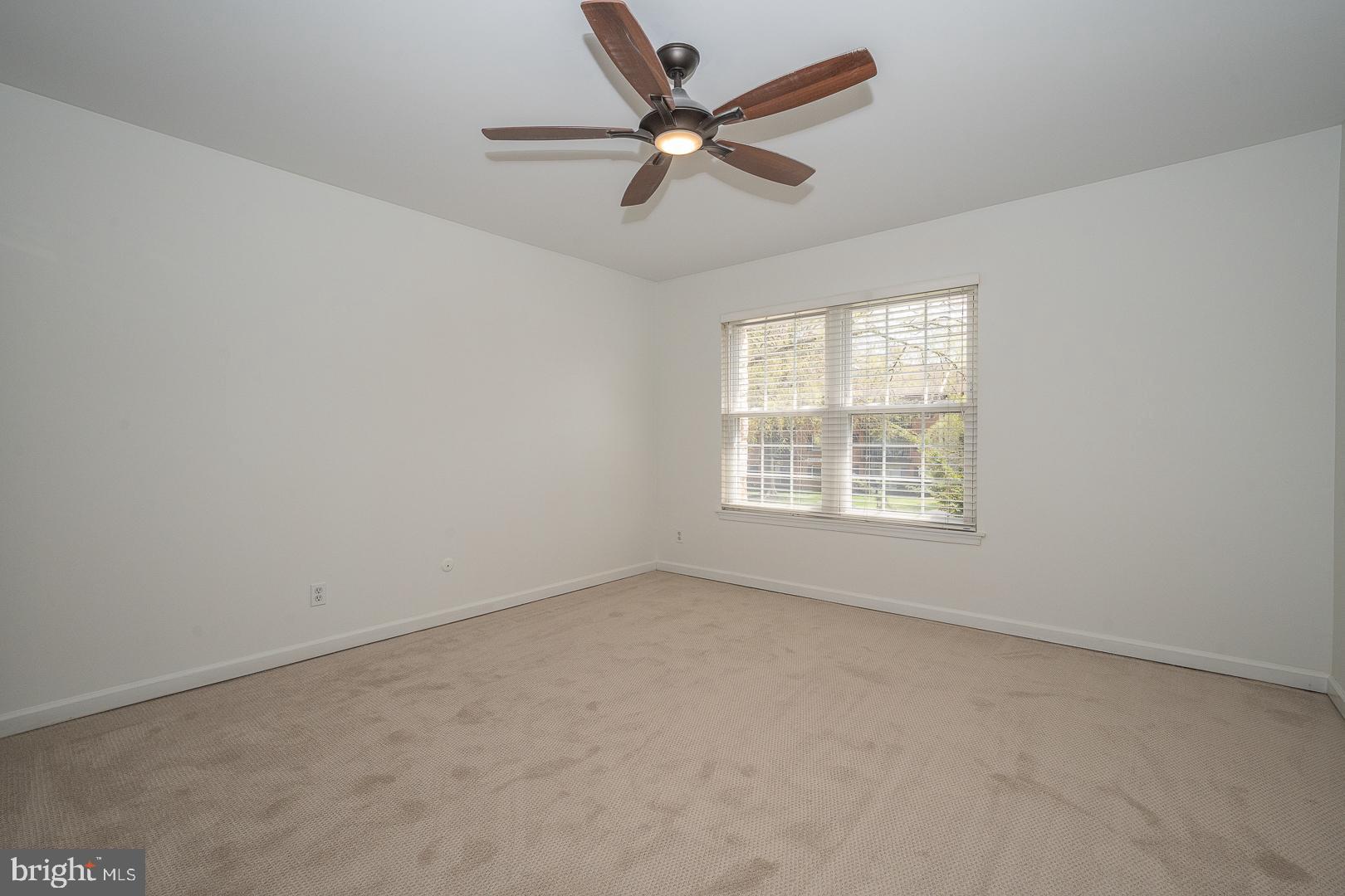 441 Drummers Lane, Unit 441 Wayne, PA 19087 - Photo 22 of 32 an empty room with a window and a fan