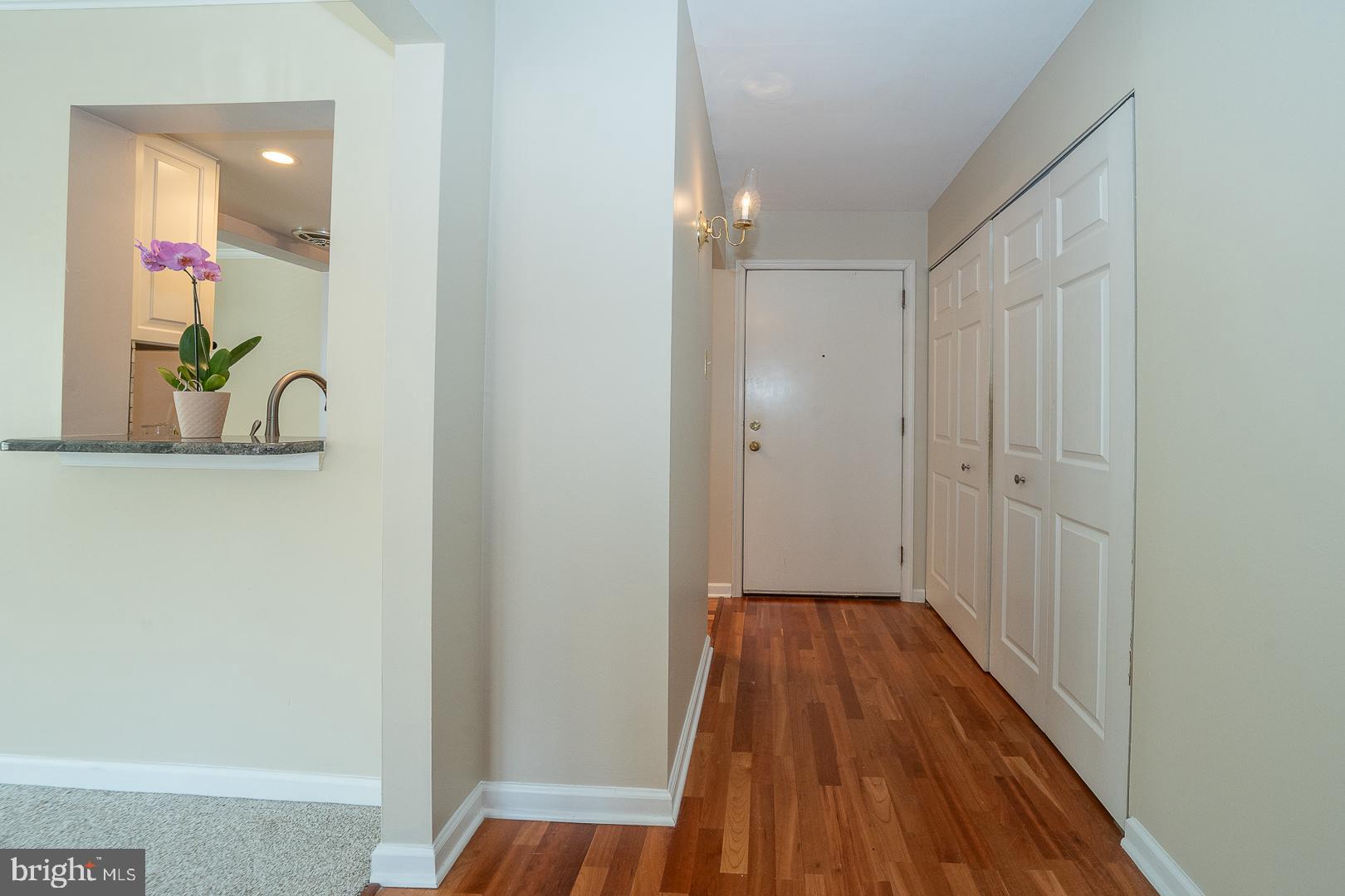 441 Drummers Lane, Unit 441 Wayne, PA 19087 - Photo 6 of 32 a view of a hallway with wooden floor and staircase