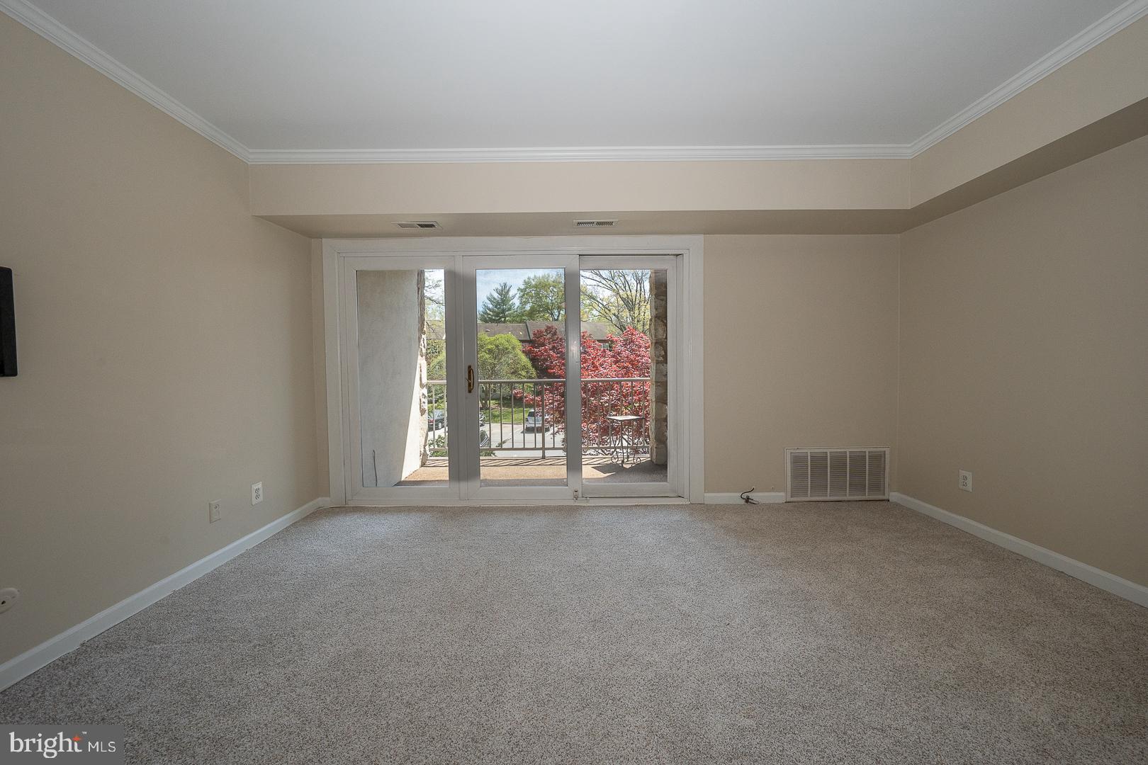 441 Drummers Lane, Unit 441 Wayne, PA 19087 - Photo 10 of 32 an empty room with an outdoor view and a window