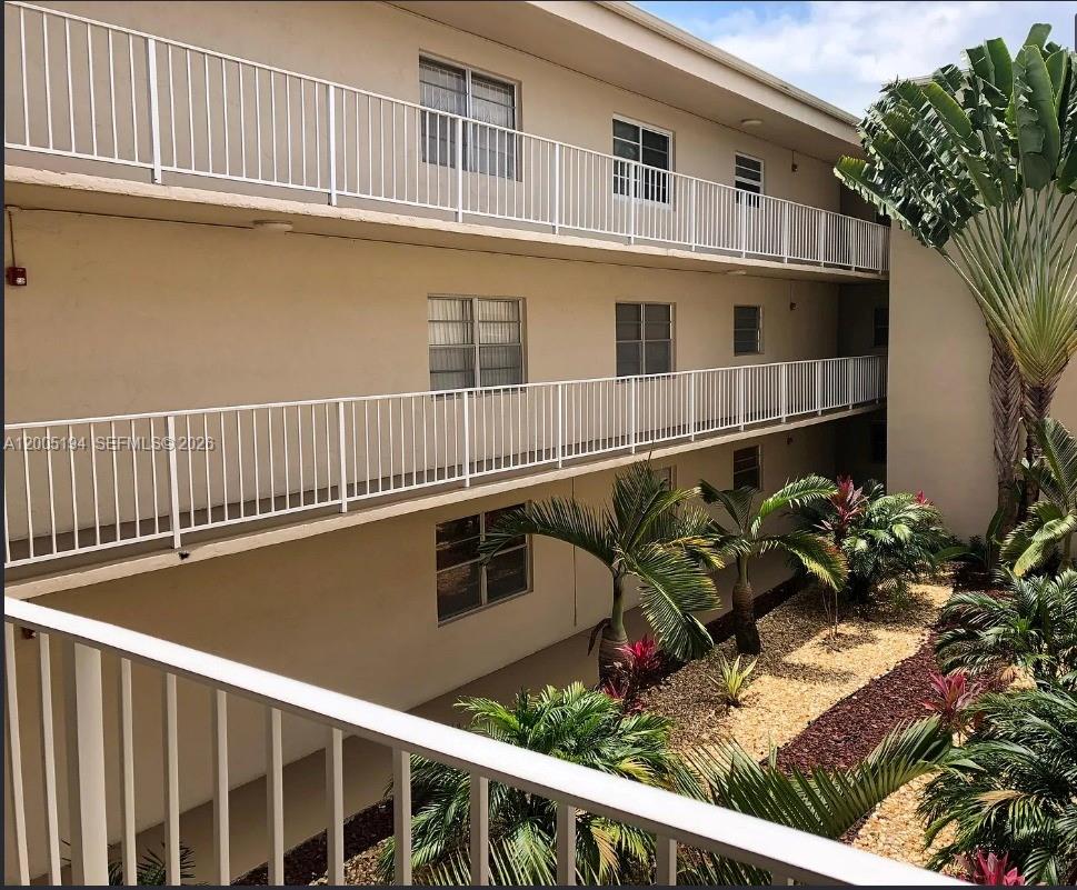 7705 Southwest 86th Street, Unit B211 Miami, FL 33143 - Photo 1 of 22 a front view of a house with a yard