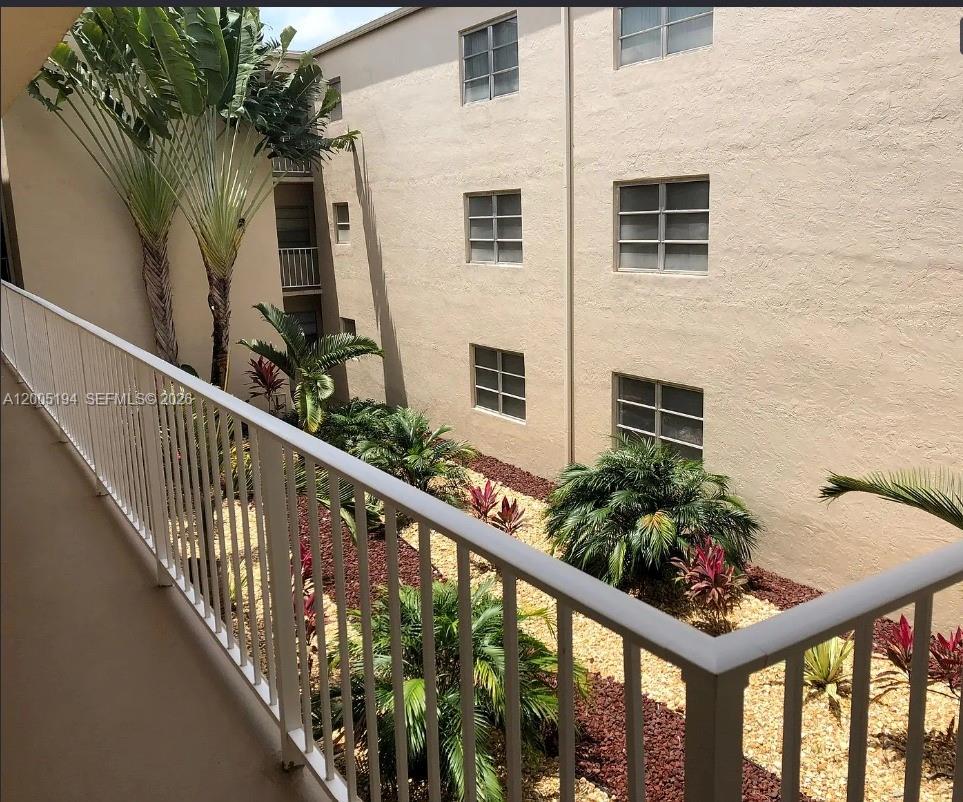 7705 Southwest 86th Street, Unit B211 Miami, FL 33143 - Photo 15 of 22 a view of a balcony with flower plants