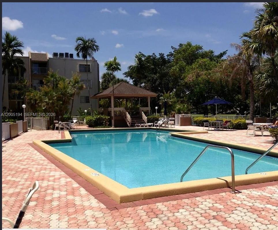 7705 Southwest 86th Street, Unit B211 Miami, FL 33143 - Photo 19 of 22 a view of swimming pool with outdoor seating
