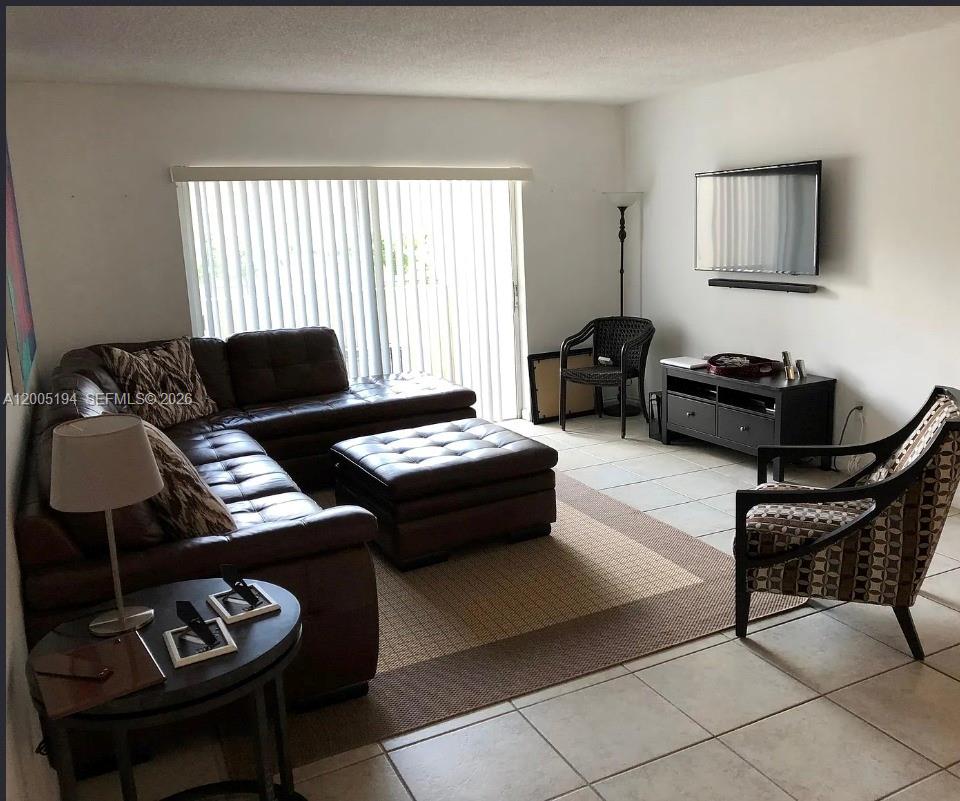 7705 Southwest 86th Street, Unit B211 Miami, FL 33143 - Photo 2 of 22 a living room with furniture and a window