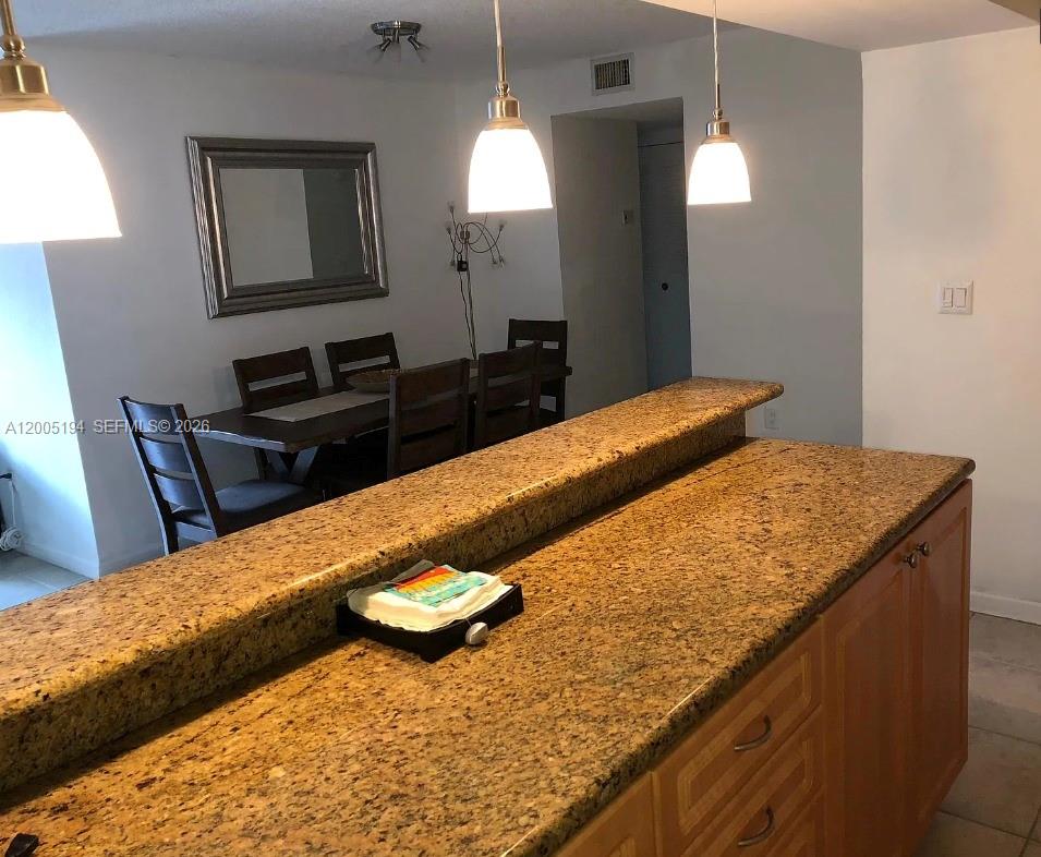 7705 Southwest 86th Street, Unit B211 Miami, FL 33143 - Photo 4 of 22 a kitchen with a sink and a refrigerator