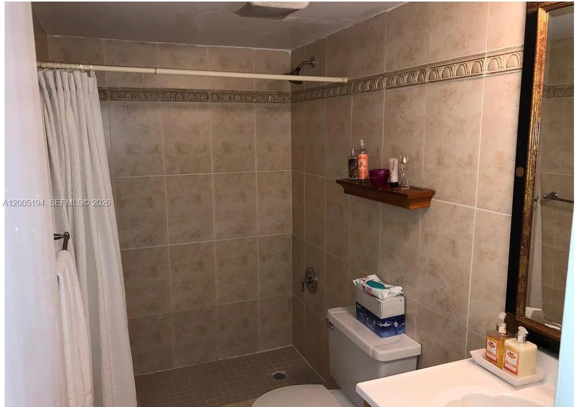 7705 Southwest 86th Street, Unit B211 Miami, FL 33143 - Photo 7 of 22 a bathroom with a shower toilet and sink