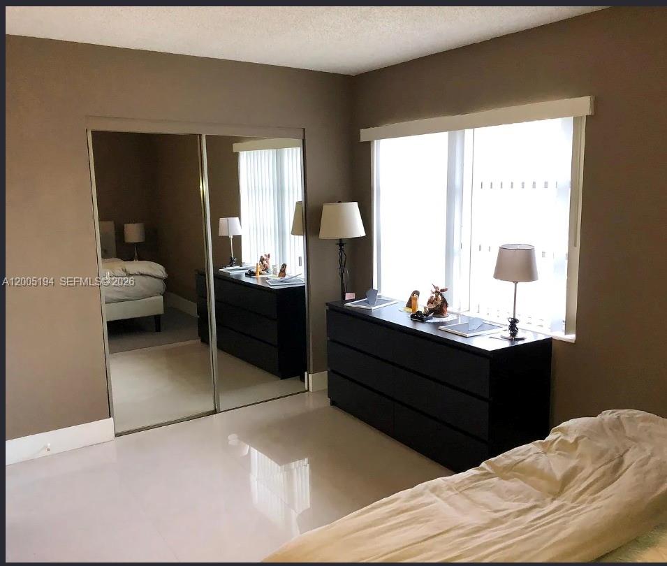7705 Southwest 86th Street, Unit B211 Miami, FL 33143 - Photo 10 of 22 a bed room with a bed and a window